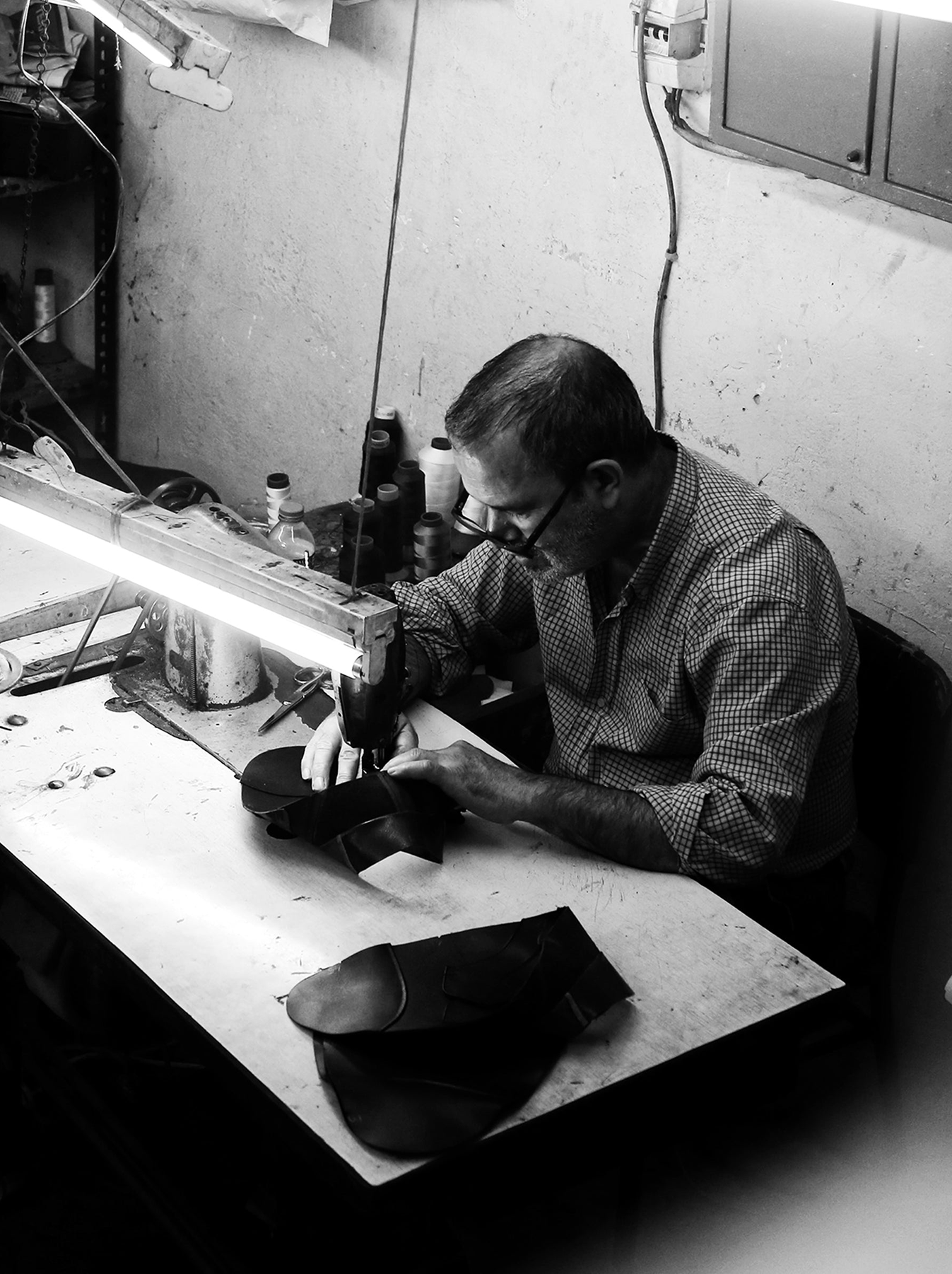 black-and-white-photo-of-a-person-sitting-by-sewing-machine.png